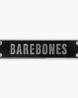 Enamel pin of a black rectangular sign with 'BAREBONES' text on a white background
