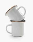 Two stacked 5 oz speckled eggshell enamel espresso cups with copper plated rims on a white background.